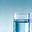 Glass of water next to a sunrise/sunset graphic depicting circadian rhythm